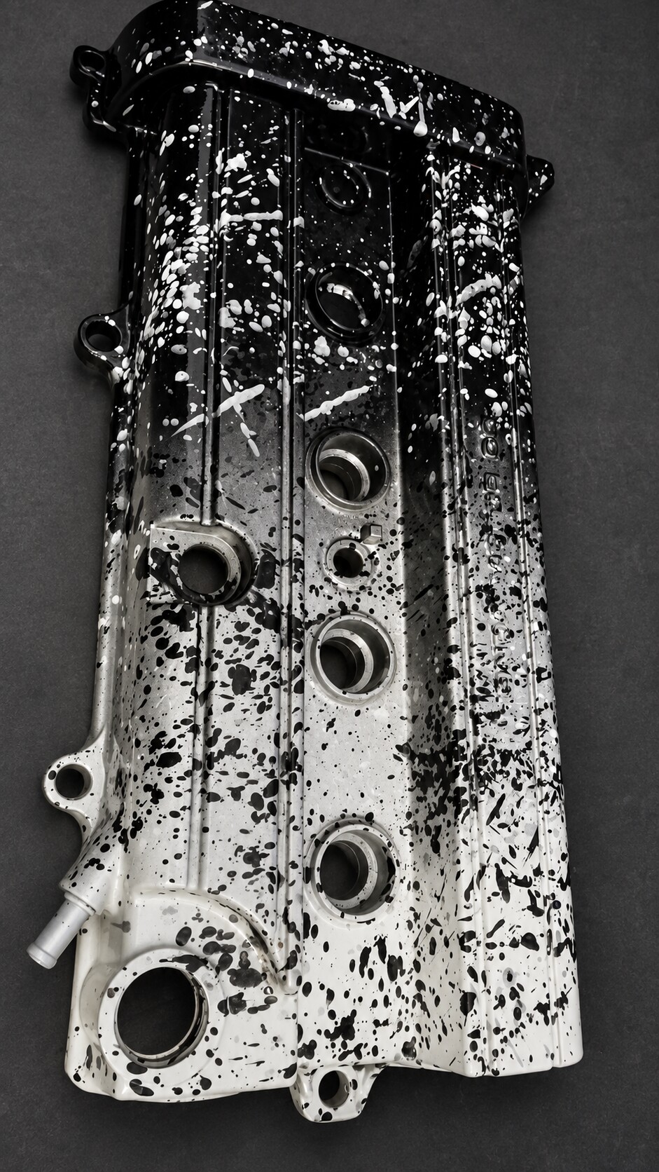 Custom black, silver, and white splatter-painted valve cover