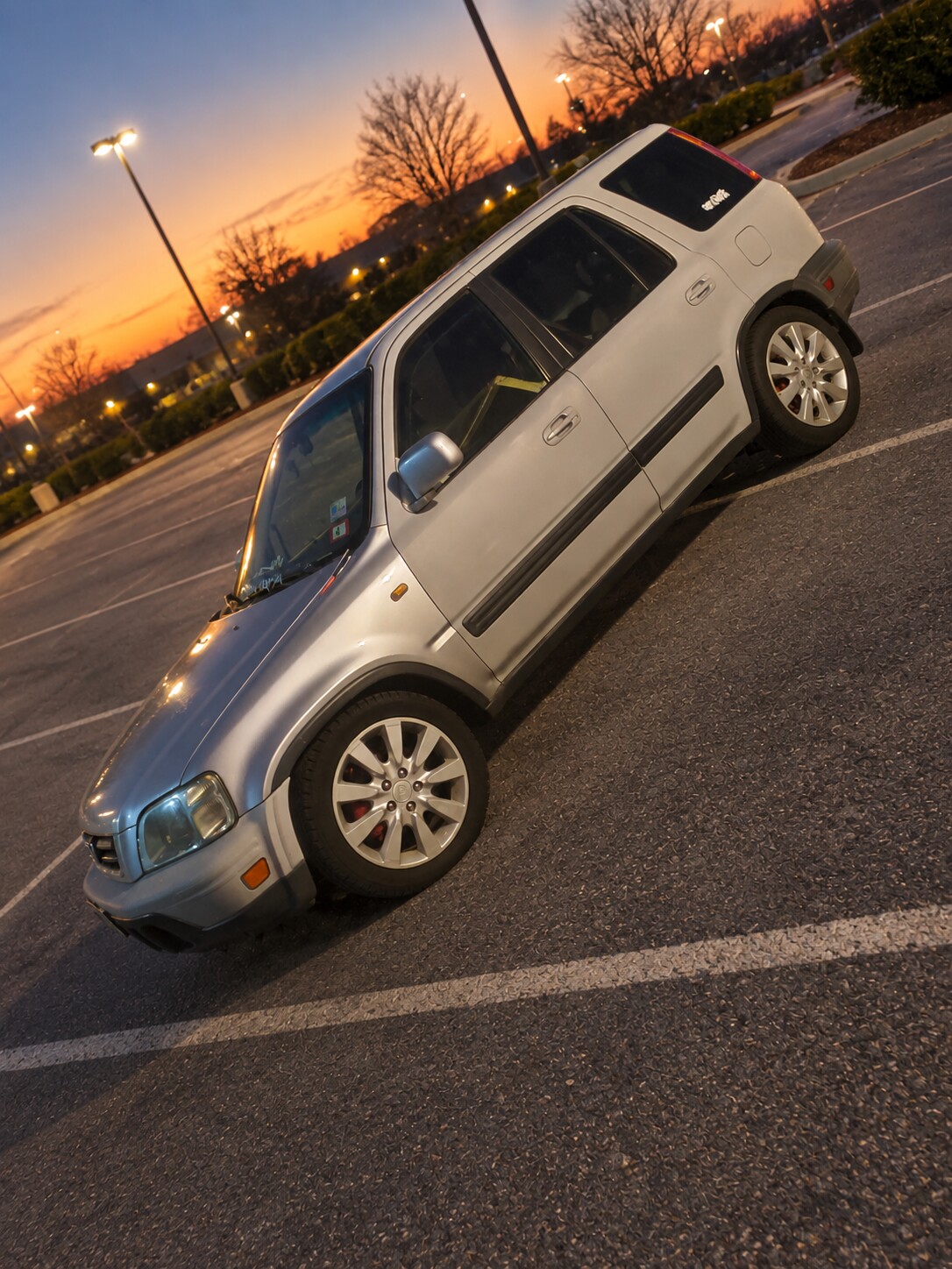 Silver custom vehicle photographed at dusk