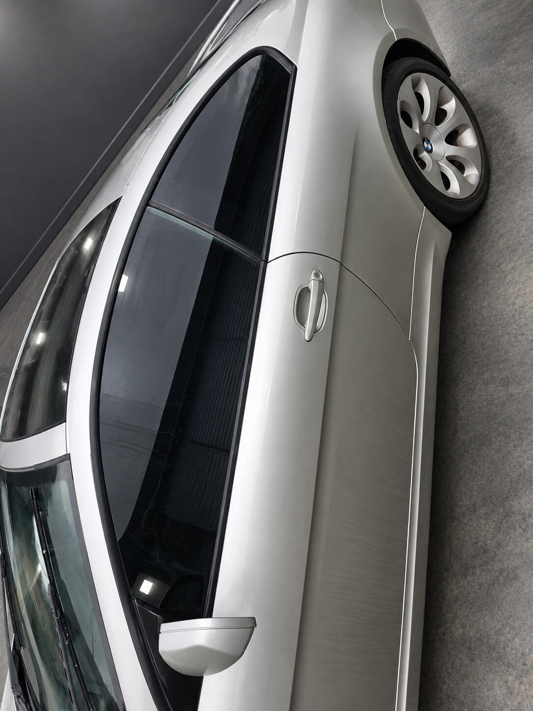 Tinted side windows on a silver BMW