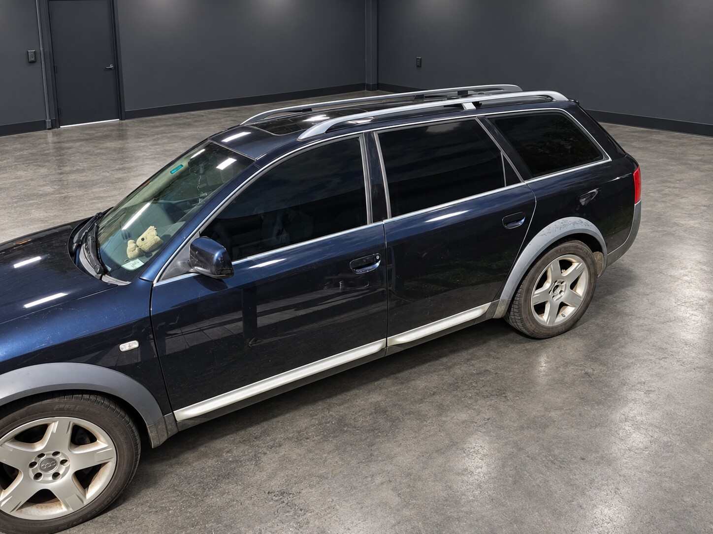 Completed window tint on a dark blue wagon