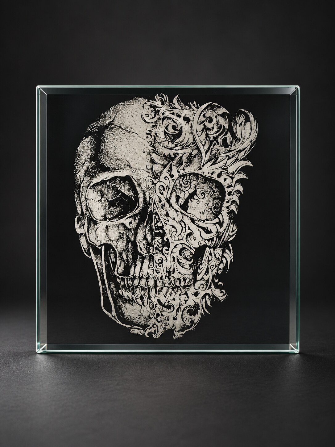 Split skull artwork laser engraved on a glass display panel